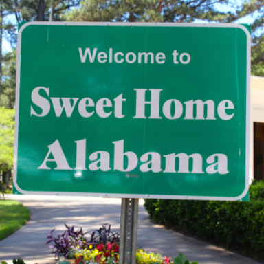 Green sign welcoming visitors to Sweet Home Alabama.