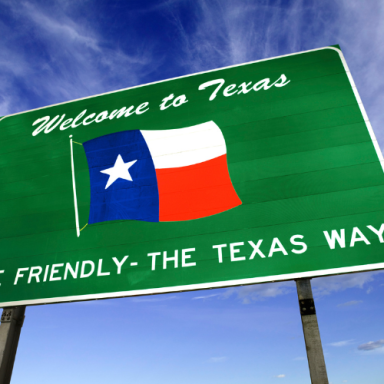 Welcome to Texas sign featuring the Texas flag and the phrase "Friendliest - The Texas Way."