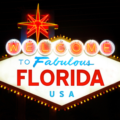 Fabulous Florida welcome sign with bright lights and a star at night.