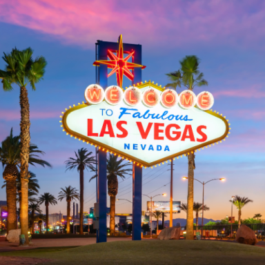 Welcome to Fabulous Las Vegas sign with vibrant sky and palm trees.