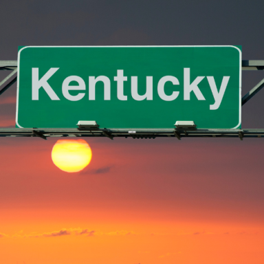 Kentucky sign with a sunset in the background.