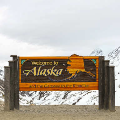 Welcome sign for Alaska with a map outline and the phrase "Gateway to the North."